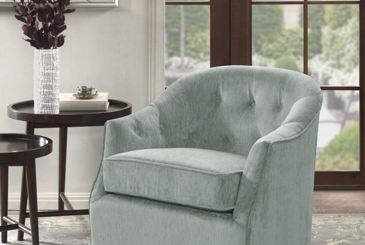 Classic meets contemporary with the Madison Park Calvin Swivel Chair. The curved wide back features elegant button tufts that add charm and elegance to the design. A high-density foam filling and solid wood frame provide exceptional comfort and support. The swivel feature allows the lounge chair to rotate on its black metal base. Upholstered in a soft light green velvet fabric