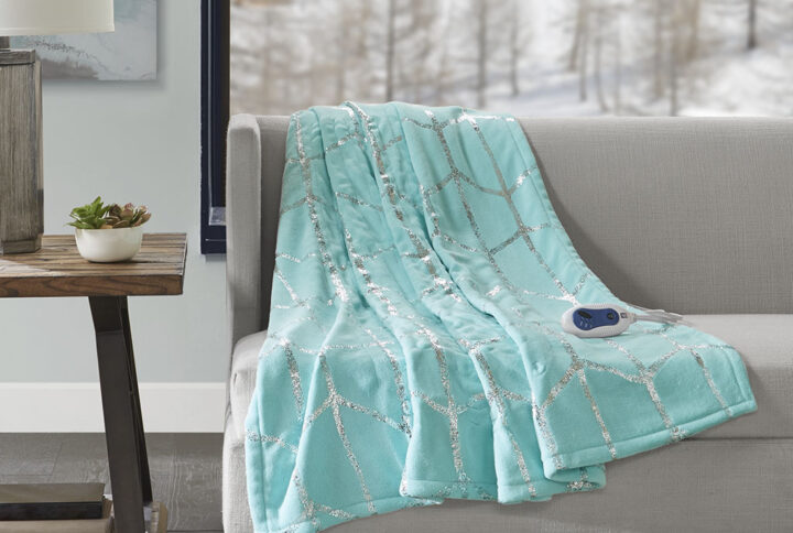 True North by Sleep Philosophy offers incredible comfort and style with the Raina Heated Metallic Print Throw. A silver metallic geometric design is beautifully printed on an ultra-soft plush aqua base fabric. Emitting virtually no electromagnetic field emissions