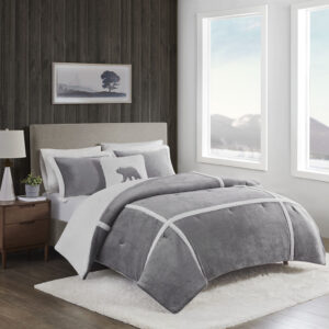 Wrap yourself in warmth and comfort with the Woolrich Orlen Plush to Sherpa Comforter Set. This set features a solid plush face with berber piping detail