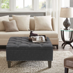 Complete your living space with the Madison Park Lindsey Tufted Square Cocktail Ottoman. This large square ottoman is upholstered fabric and features a button tufted top with piping details to create a chic traditional look. A nail head trim on bottom of the frame adds an elegant touch to the design