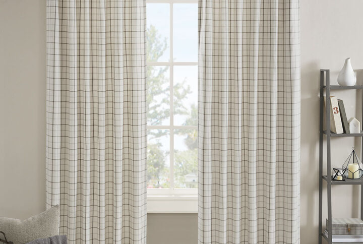 The Madison Park Anaheim Plaid Rod Pocket and Back Tab Panel with Fleece Lining is an effortlessly stylish and casual addition to your home decor