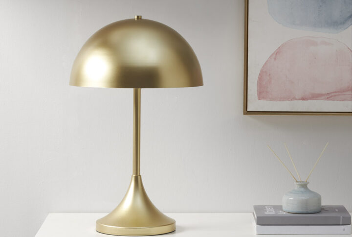 Illuminate your space with the art deco-inspired Bryson table lamp from Ink+Ivy. The elegant dome-shaped design features a gold metal shade and base