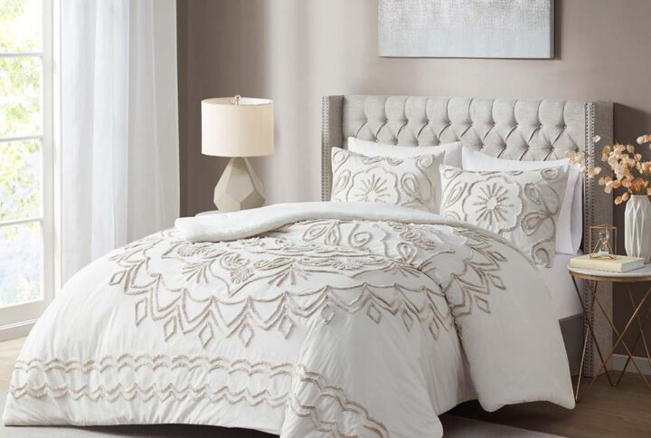 The Madison Park Violette 3 Piece Tufted Cotton Chenille Comforter Set offers a globally inspired update to brighten your bedroom decor. A large tufted chenille medallion is displayed in the center of the comforter