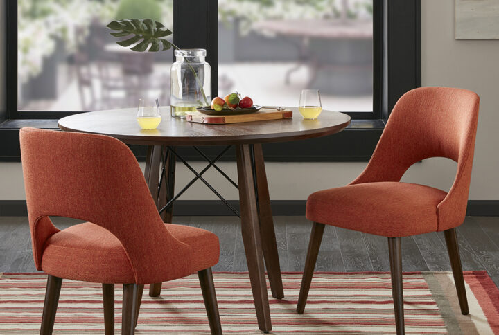 Dress up your dining room with the INK&IVY Nola Dining Chair. Upholstered in an orange fabric