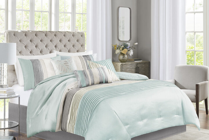 Amherst's modern color blocked design is a simple way to add style to your room. This comforter is covered in larges stripes in shades of aqua and grey. Made from polyester jacquard and a brushed fabric reverse this comforter is soft to the touch and is machine washable for easy care. The comforter set includes two matching standard shams and three decorative pillows that accent the color blocked look.