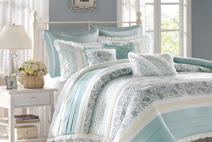 The Madison Park Dawn 9 Piece Cotton Percale Duvet Cover Set offers a shabby chic update to your bedroom decor. A paisley print is featured on the cotton duvet cover with pintucked fabric separated by lace taping embellishments. Around the edge