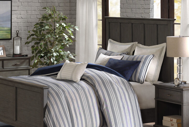 The Madison Park Signature Farmhouse Comforter Set sports a navy and ivory woven jacquard stripe pattern for a fresh update to your space. The versatile color palette works well in any style bedroom. The cotton blend comforter is oversized and overfilled to provide exceptional warmth and comfort with a removable cover that makes it easy to clean. Coordinating shams highlight the mixed weaves design on the top of bed