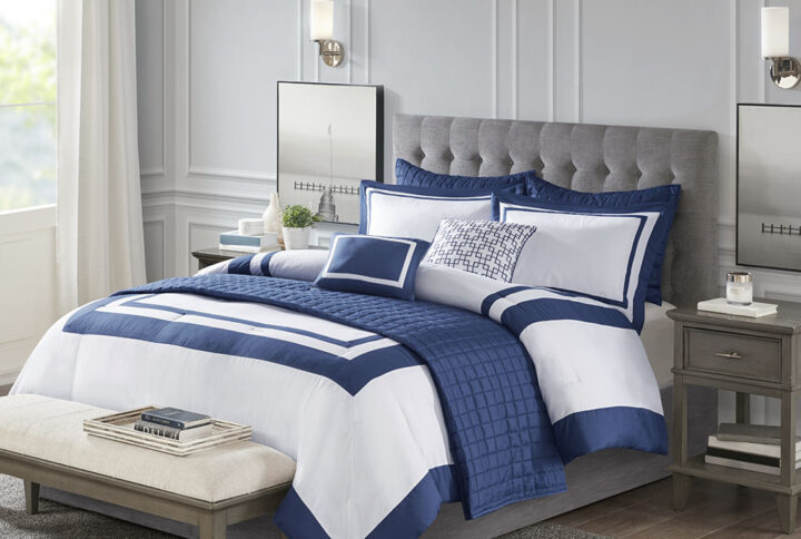 This Heritage hotel bedding collection includes a comforter and quilt that both come with matching shams to complete a luxurious layered look. The soft comforter and shams showcase a bold border on a white ground with a solid white reverse