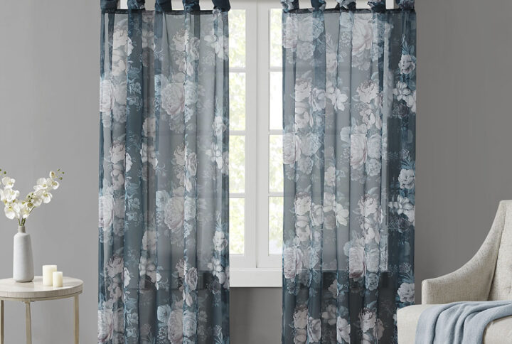 The Madison Park Simone Printed Floral Twist Tab Top Voile Sheer brings a soft and romantic touch to your home decor. This voile sheer curtain panel features a beautiful blush and neutral printed floral on a dark navy ground for a rich and stylish contrast