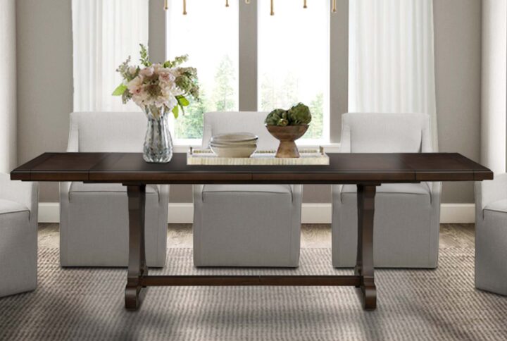 Bring your dining room and family together with the elegant traditional design of this extendable dining table. The solid wood veneer tabletop flaunts a beautiful and rich brown finish with a trestle style base to create a gorgeous refined look. Natural color variations will occur due to the nature of the wood