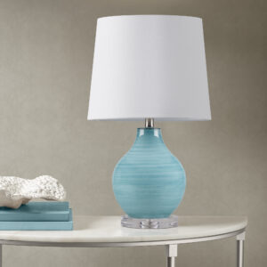 Transform your space with the Maelle Glass Table Lamp by 510 Design – where artistry meets functionality. Crafted from stunning blue aqua swirl blown glass