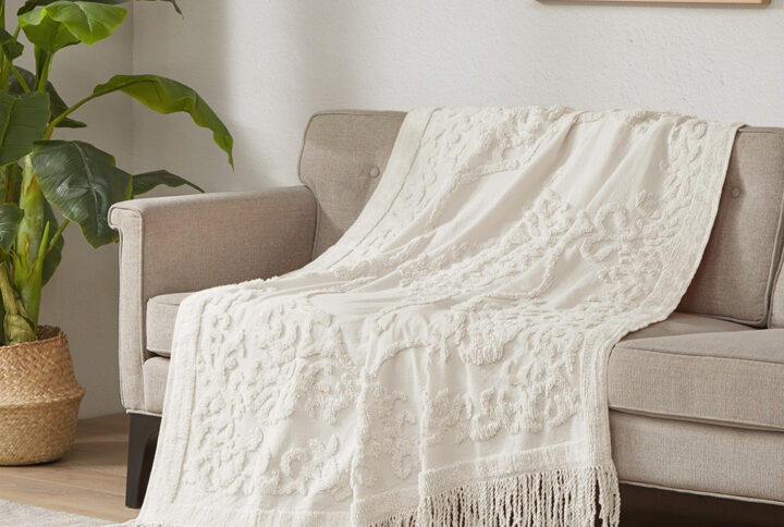 The Madison Park Chloe Cotton Tufted Throw provides a luxurious addition to your home decor. This ivory throw flaunts an elegant tufted chenille design with a 4-inch fringe on each end