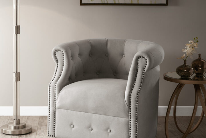 The Madison Park Owen Swivel Chair provides a chic transitional addition to your home décor. Featuring a low barrel back with button tufting accents