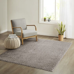 The Madison Park Camdyn Super Soft Polyester Shag Area Rug offers a chic modern addition to your living space. This solid grey shag area rug flaunts a super soft