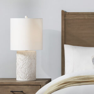 this ivory table lamp is crafted from resin with a slightly distressed finish. Paired with a coordinating off-white cylinder shade