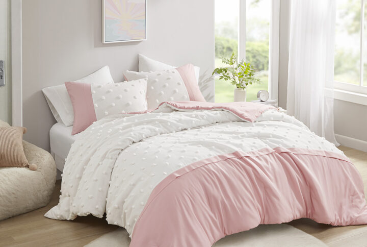 The Intelligent Design Shay comforter set features a vibrant colorblock design accented by clipped jacquard pompoms that add texture and charm. The comforter brings a pop of color to your bedroom