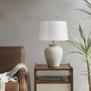 The INK+IVY Anzio Ceramic Table Lamp offers a simple and traditional addition to brighten your home decor. This table lamp features a round ceramic base with a rich cream finish to create a charming neutral look. The white lamp shade showcases a drum shape that complements the design of the base and softly filters the light