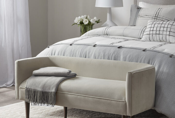 The Madison Park Farrah Accent Bench offers a fashionably unique update to your living room or entryway. This accent bench is upholstered in a rich cream velvet fabric and features a low back and sides