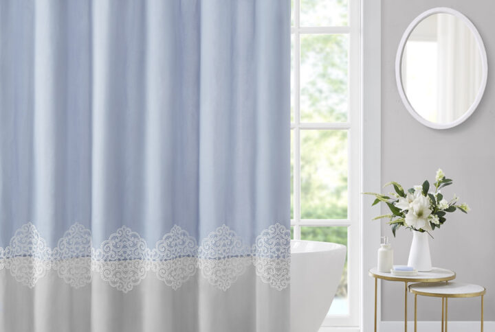 Color block style with a feminine look and feel; The Madison Park Panache shower curtains combines a color block design in light blue and grey hues while a lattice embroidery for a beautiful and delicately