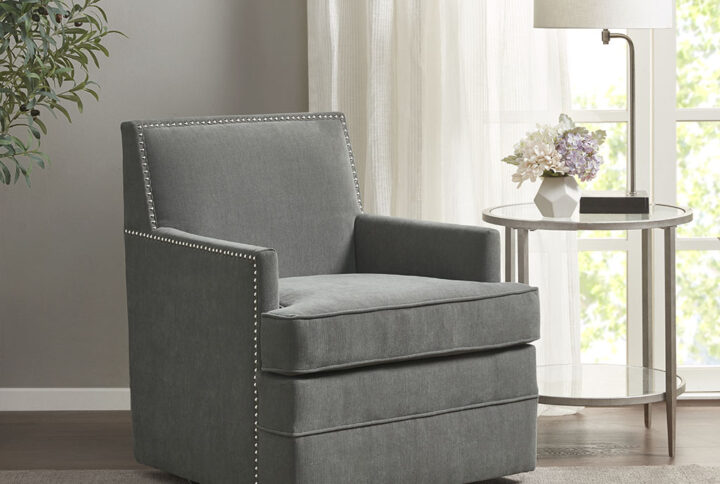 The Madison Park Circa Upholstered Swivel Chair offers a comfortable and sophisticated update to your home. This swivel chair is upholstered in a lush grey fabric and features a silver nail head trim along the arms and back