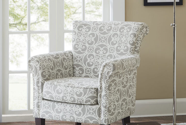 Add an eye-catching touch to your living room with the Madison Park Brooke Tight Back Club Chair. This accent chair features an all-over fretwork pattern on the upholstery that creates a stunning transitional look. The double row nailhead trim on the front of the arms and the sides of the back add an elegant accent to the design. With a comfortable loose cushion and sturdy solid wood legs