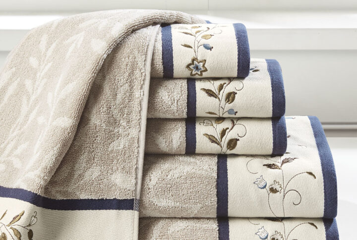 Add a touch of elegance to your bathroom decor with our Madison Park Serene Embroidered Cotton Jacquard 6 Piece Towel Set. These cotton towels feature a jacquard leaf pattern with a floral embroidered hem