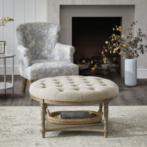 The Martha Stewart Cedric Accent Ottoman brings a touch of elegant style to your living space. This round ottoman features a button tufted top upholstered in a rich cream fabric with high density foam filling providing exceptional comfort. A lower veneer shelf and solid wood turned legs showcase a smooth reclaimed grey finish to complement the upholstery. Add this round accent ottoman to your living room to give your space a touch of elegance and functionality to your decor. Assembly is required and no tools are needed.