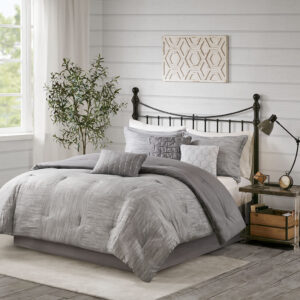 The Madison Park Walter 7 Piece Printed Seersucker Comforter Set offers a chic modern update to your bedroom. This grey comforter set features a pieced