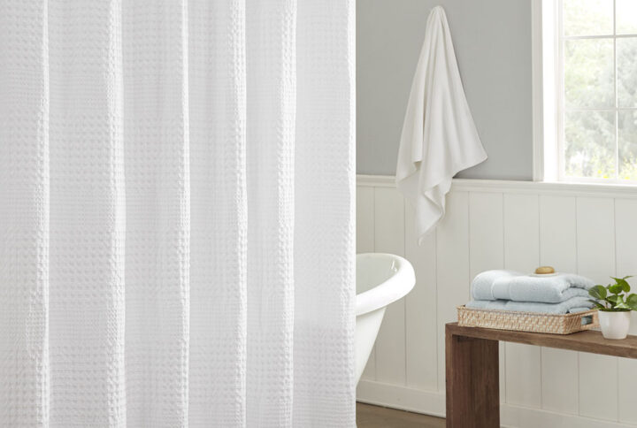 Give your bathroom a spa-like allure with the Madison Park Arlo Super Waffle Textured Solid Shower Curtain. This solid White shower curtain features a heavy waffle weave base fabric that creates a rich texture for a simple and stylish update. The medium weight fabric allows a natural and rich drapability