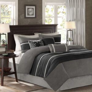 The Madison Park Palmer 7 Piece Comforter Set offers a classic and refined update to your bedroom decor. This transitional style comforter features a pieced microsuede design in rich contrasting black and grey colors to create an incredibly soft look and feel. The 2 matching shams also flaunt a pieced construction to coordinate with the faux suede comforter. A solid grey bed skirt and 3 decorative pillows with a mix of embroidered designs add the perfect finishing touches to complete this lush traditionally-inspired comforter. Machine washable for easy care