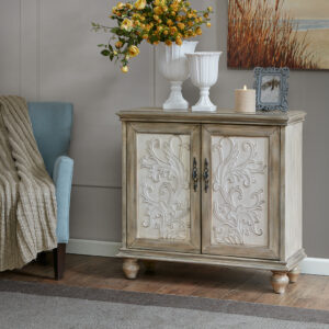 The Madison Park Driscoll 2-Door Cabinet offers a perfect blend of functionality and style for your home decor. This accent chest features a floral design on the cream-hued door panels that adds an elegant touch to the design. The natural-hued frame and legs complement the doors