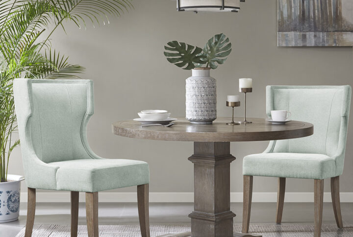 Define your dining room with the elegance of the Madison Park Carson dining chair. This upholstered dining chair features a wingback style back with piping details around the frame that create clean lines and curves