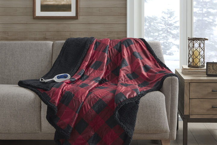 Stay warm and indulge in pure comfort with the Woolrich Linden Heated Throw. This red heated throw features a soft mink face with a solid and cozy berber reverse that creates a luxurious look with an incredibly soft feel. The attached controller provides 3 different temperature settings to provide the perfect level of warmth that keeps you the most comfortable when bundled up. The controller also has a 2 hour auto shut off timer to ensure your safety during prolonged use. Machine washable for easy care