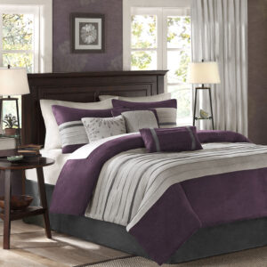 The Madison Park Palmer 7 Piece Comforter Set offers a classic and refined update to your bedroom decor. This transitional style comforter features a pieced microsuede design in rich contrasting plum and grey colors to create an incredibly soft look and feel. The 2 matching shams also flaunt a pieced construction to coordinate with the faux suede comforter. A solid grey bed skirt and 3 decorative pillows with a mix of embroidered designs add the perfect finishing touches to complete this lush traditionally-inspired comforter. Machine washable for easy care