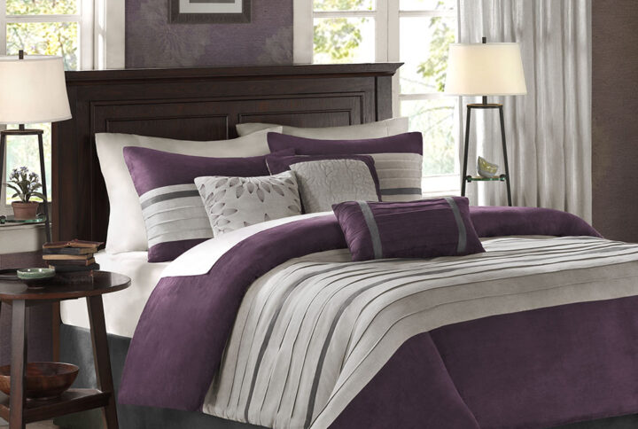 The Madison Park Palmer 7 Piece Comforter Set offers a classic and refined update to your bedroom decor. This transitional style comforter features a pieced microsuede design in rich contrasting plum and grey colors to create an incredibly soft look and feel. The 2 matching shams also flaunt a pieced construction to coordinate with the faux suede comforter. A solid grey bed skirt and 3 decorative pillows with a mix of embroidered designs add the perfect finishing touches to complete this lush traditionally-inspired comforter. Machine washable for easy care