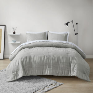 Refresh your bedroom style with the modern allure of the Madison Park Essentials Nimbus 7 Piece Comforter Bedding and Sheet Set. The comforter features a motif of alternating solid and textured stripes to create a casual and contemporary look