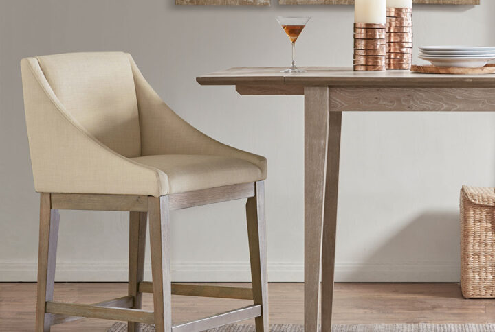 The Madison Park Simon Counter Stool provides a pure and simple update to your dining decor. Crafted with graceful sloped arms