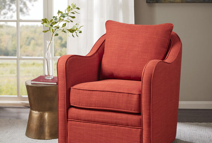 Bring simple comfort to your living room decor with the Madison Park Brianne Wide Seat Swivel Arm Chair. This swivel chair features a loose back and seat cushion that is fully upholstered for a chic transitional look. Double piping details along the frame accent the design