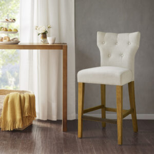 Change up your kitchen decor with the stunning style of the Madison Park Avila Tufted Back Counter Stool. This counter stool features a high button-tufted back upholstered in cream color fabric