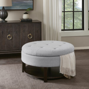 Don’t sacrifice style for storage with the Madison Park Miller Round Storage Ottoman. The round storage ottoman features a Light Grey upholstered tufted top that opens to reveal ample storage space. A lower veneer shelf provides storage for magazines and newspapers. Incorporate this round ottoman to your home to centralize the clutter and add a stylish touch to your living room. Removable cushion