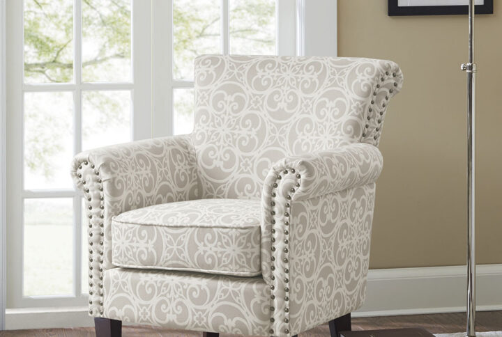 Add an eye-catching touch to your living room with the Madison Park Brooke Tight Back Club Chair. This accent chair features an all-over fretwork pattern on the upholstery that creates a stunning transitional look. The double row nailhead trim on the front of the arms and the sides of the back add an elegant accent to the design. With a comfortable loose cushion and sturdy solid wood legs