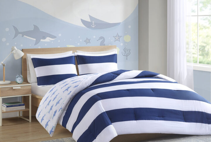 Add a bright and playful update to your kid's bedroom with the Urban Habitat Kids Sammie Cotton Cabana Stripe Reversible Comforter Set. This soft cotton comforter and 2 shams (1 in Twin) features a classic navy and white cabana stripe with a cool shark print on the reverse