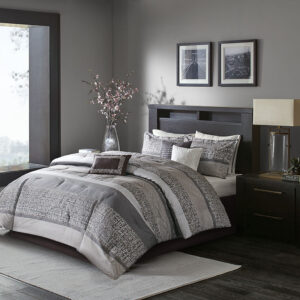 Give your bedroom a new luxurious look with the Madison Park Rhapsody 7 Piece Jacquard Comforter Set. This jacquard comforter features a grey and taupe stripe design of several different motifs on the face with a solid grey reverse