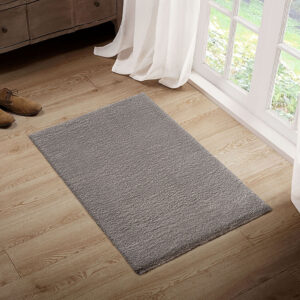 The Madison Park Camdyn Super Soft Polyester Shag Area Rug offers a chic modern addition to your living space. This solid grey shag area rug flaunts a super soft