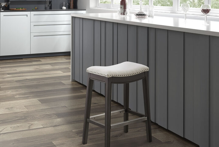 Complete your kitchen dining space with the sophisticated Madison Park Belfast 27.36" Counter Stool. This counter stool features a cream upholstered seat and a solid wood frame with a dark grey finish to create a stunning contemporary look. A pewter nail head trim around the edge of the upholstery adds an elegant accent