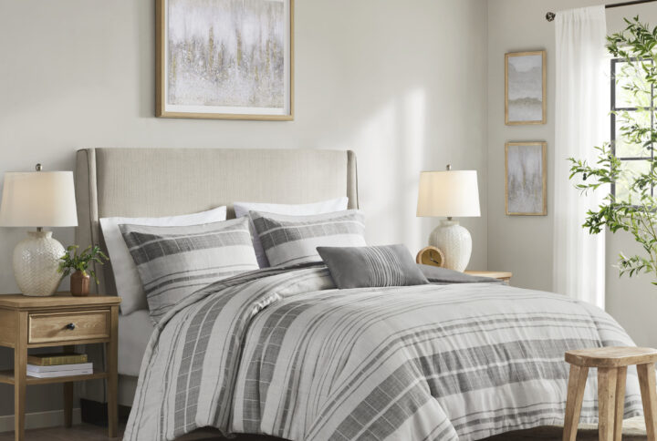 This modern farmhouse bedding set features printed black stripes on a grey and white background made of a cotton/poly slub fabric for a linen-like look. The cotton/poly blend offers softness