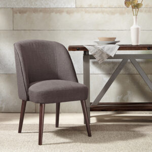 The soft curves of the wraparound back of this dining chair highlight the thin tapered legs