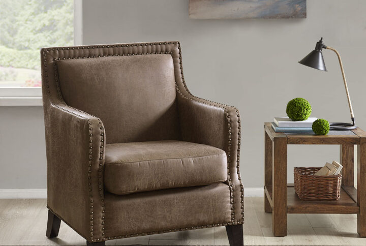 The INK+IVY Shasta Accent Chair introduces a rich and handsome look to your living space. This accent chair is upholstered in faux leather and accented with brass nail buttons