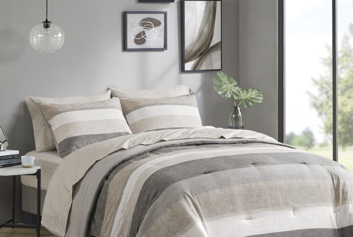 Revamp your bedroom style with the Madison Park Essentials Jaxon bed in a bag. This modern comforter set features a stripe pattern in alternating grey