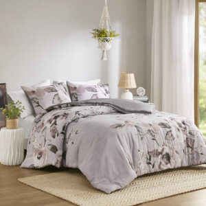 This shabby chic comforter set features a large scale engineered floral print design in shades of mauve